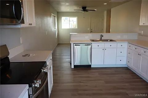 Modern white kitchen with premium finishes at the Arditto residence